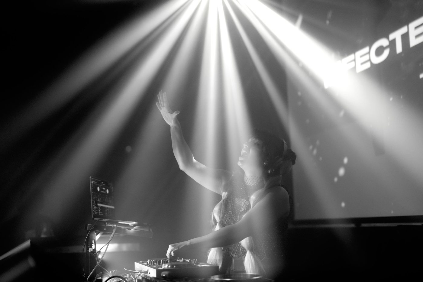 Black and white shot of JuLix under beams of light