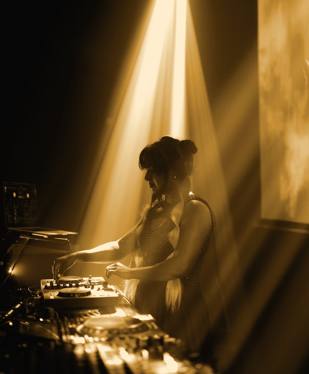 JuLix silhouetted in a golden beam of light